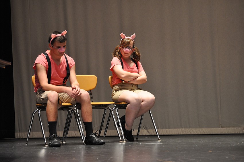 Matthew Kenner, as Benny the pig and Emily Gartenberg, playing Jenny the pig, sat alone as the Wicked Witch went to trial.