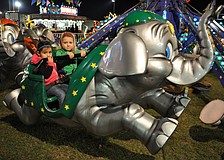 Alena and Ayanna Fernandez enjoy an elephant ride.