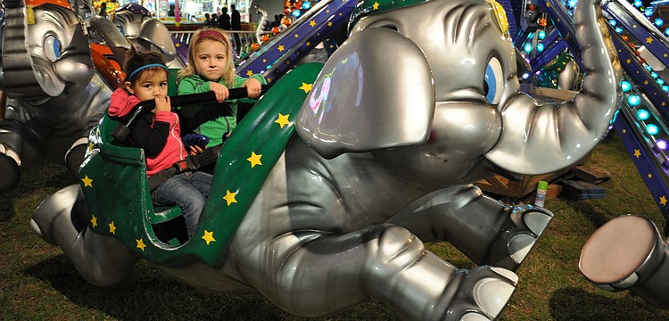 Alena and Ayanna Fernandez enjoy an elephant ride.