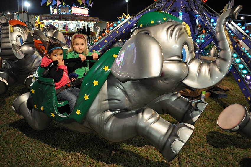 Alena and Ayanna Fernandez enjoy an elephant ride.