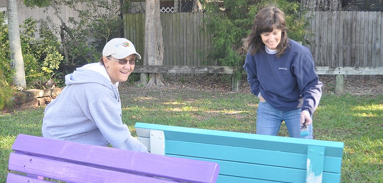Claudia Benz and Sheree Cade paint a bench.