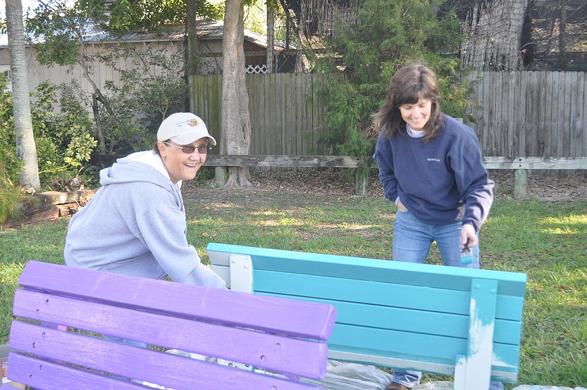 Claudia Benz and Sheree Cade paint a bench.
