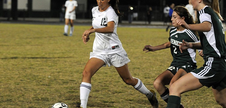 Lakewood Ranch senior Chelsea Martin attempts to clear the ball past a pair of Venice defenders in the Class 4A-Region 3 semifinals Jan. 26.