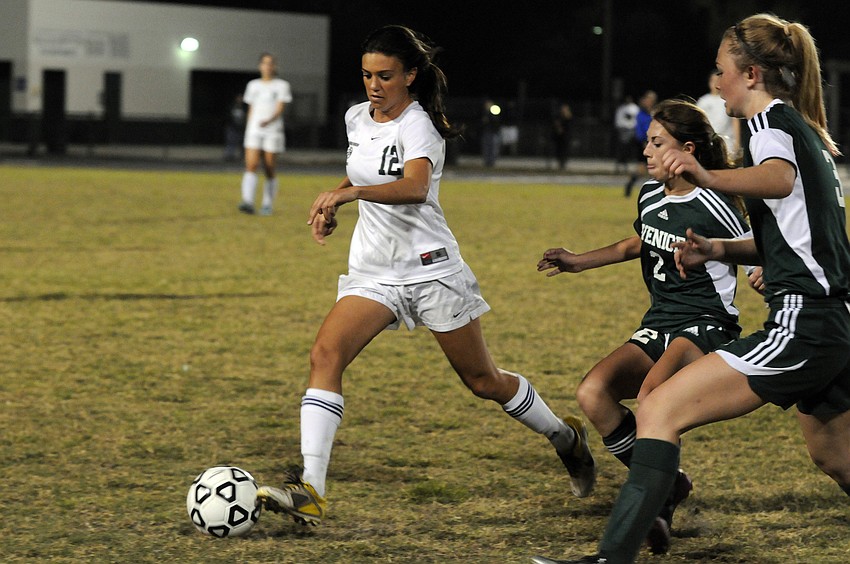 Lakewood Ranch senior Chelsea Martin attempts to clear the ball past a pair of Venice defenders in the Class 4A-Region 3 semifinals Jan. 26.