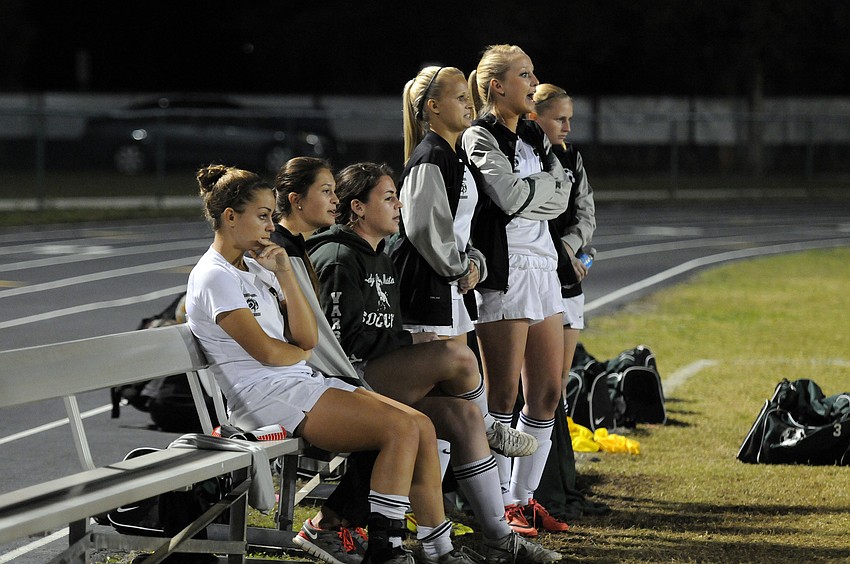Members of the Lakewood Ranch High girls soccer team look on as their teammates try to keep Venice from scoring in the final two minutes of the regional semifinals.