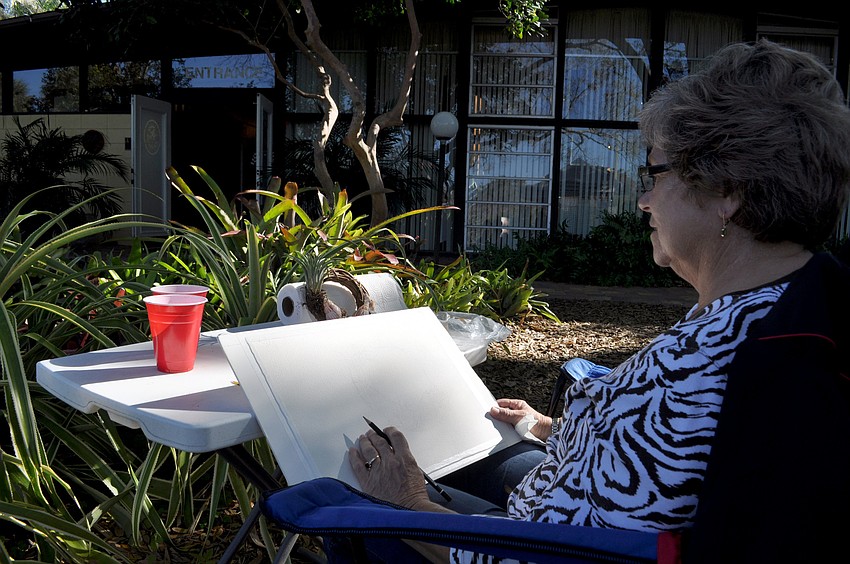 Barbara Perry sketches a plant.