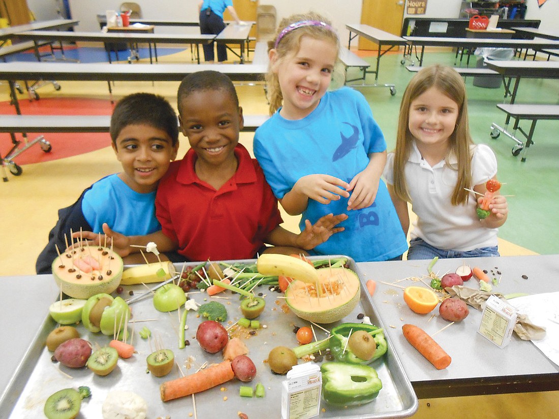 Braden River Elementary School second-graders Nish Patel, Derick Cooper, Ashlynn Poznanski and Britlee Yant worked in teams to make art with fruits and vegetables.