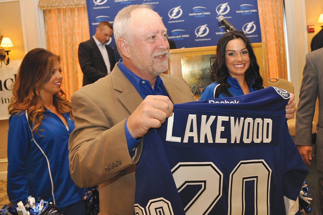 Schroeder-Manatee Ranch President and CEO Rex Jensen shows off the Lakewood Ranch Tampa Bay Lightning jersey he received from Lightning Vice President and General Manager Steve Yzerman, during a Jan. 25 press conference.