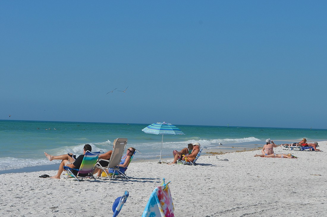 The Longboat Key coastline near the Broadway Beach Access was dotted with umbrellas and towels Tuesday. Photos by Kurt Schultheis.