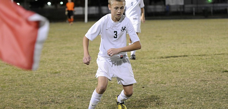 Sophomore midfielder Jake Dube attempts to maintain possession for the Mustangs in the first half.