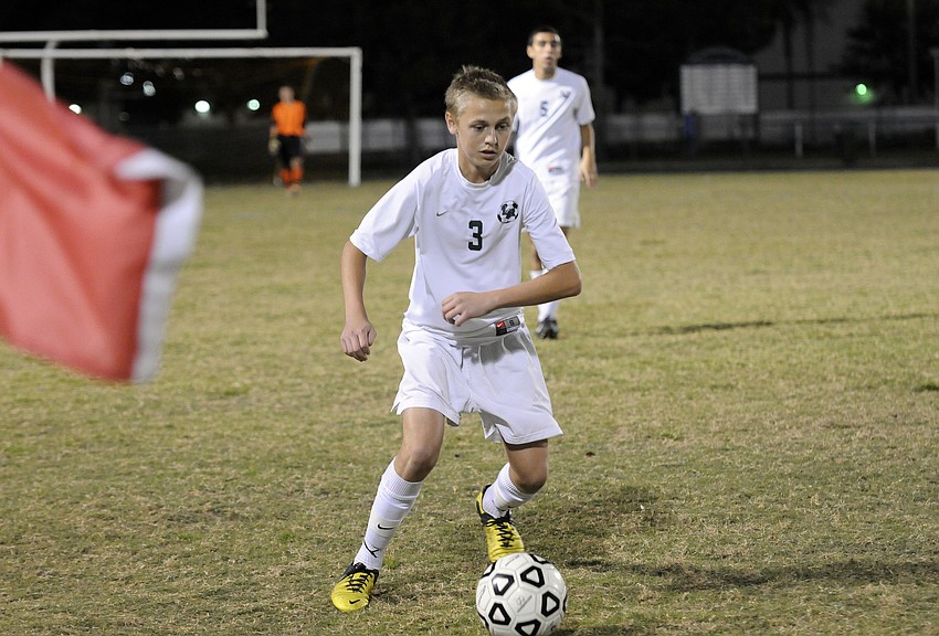 Sophomore midfielder Jake Dube attempts to maintain possession for the Mustangs in the first half.