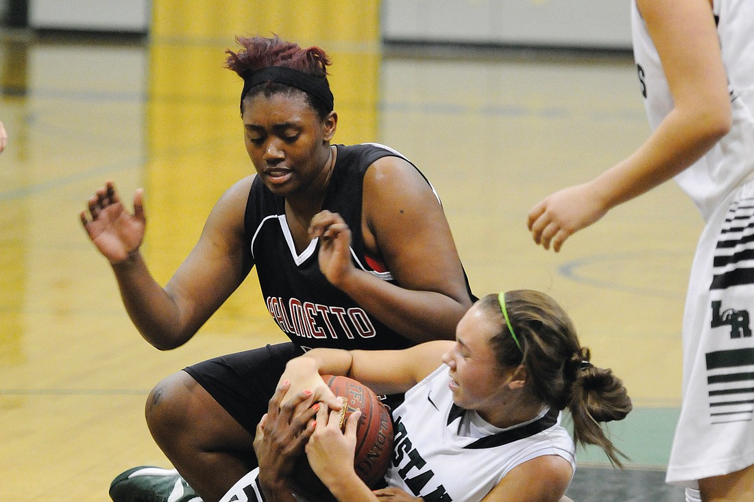 Lakewood Ranch High junior Emily Bulfin battled a pair of Palmetto players for a rebound in the third quarter.