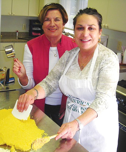 Connie Mederos-Jacobs, right, teaches Kathy Brooks how to prepare mamaliga. Courtesy photo.