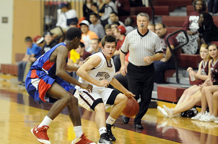 Braden River senior guard Zach Bolan attempts to dribble around a Manatee High defender.