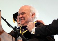 Dr. Donal Oâ€™Shea smiles out at the crowd after being presented with the Presidential medallion.