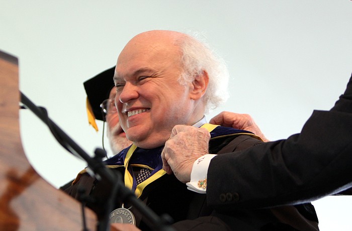 Dr. Donal Oâ€™Shea smiles out at the crowd after being presented with the Presidential medallion.