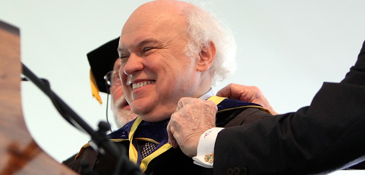 Dr. Donal Oâ€™Shea smiles out at the crowd after being presented with the Presidential medallion.