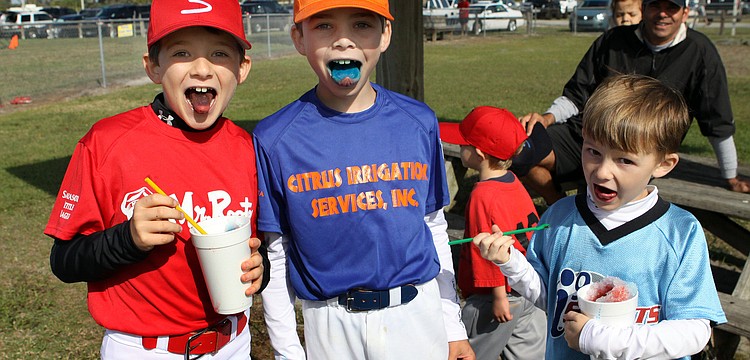 Kai Sutter, 9, Joseph Sparma, 8, and Andrew Sutter, 6 show off their colorful tongues after eating their snow cones.