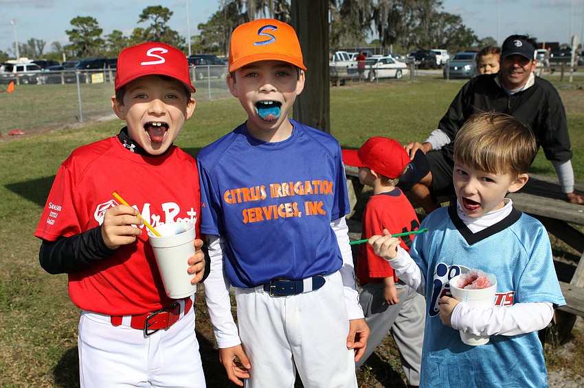 Kai Sutter, 9, Joseph Sparma, 8, and Andrew Sutter, 6 show off their colorful tongues after eating their snow cones.