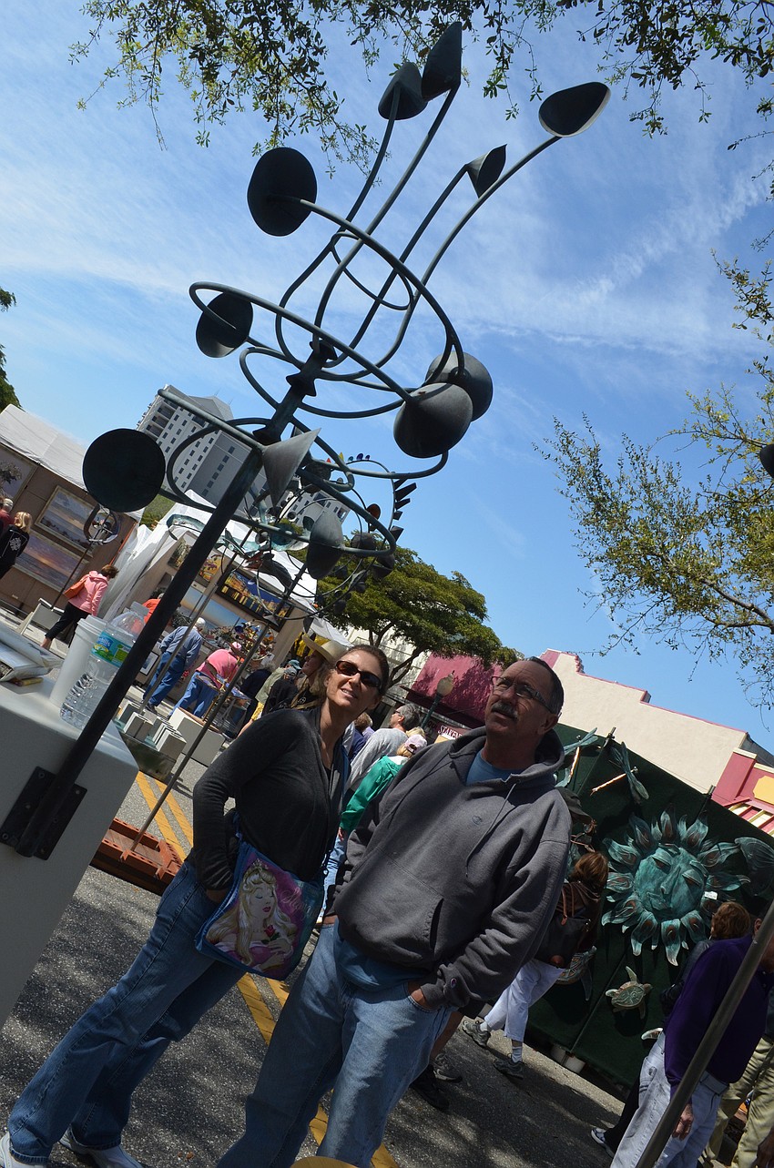 Local residents Lisa and Bill Weaver check out the interesting sculptures at the festival.