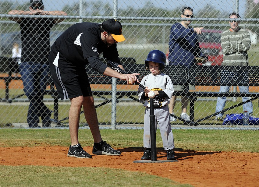 Merrick Rixon, 4, received some tips from his coach before his very first at bat.