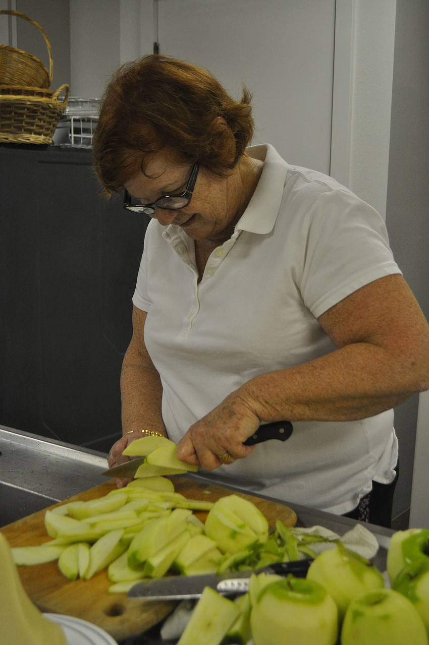 Sous chef Lynn Burton slices apples for the puff pastry dessert.