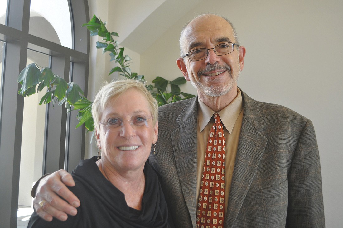Wilma Davidson, Ed.D., and Wally Lamb bond over their shared love of teaching at a Feb. 15 luncheon at the University of South Florida Sarasota-Manatee.