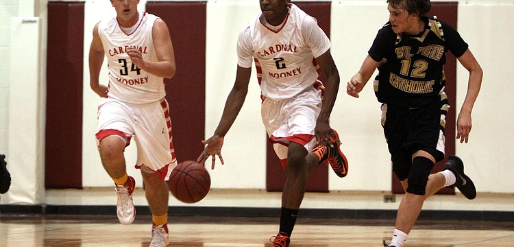 Cardinal Mooneyâ€™s Antonio Blakeley, No. 2, runs up the court with teammate Mitch Arimura, No. 34, and being followed by St. Petersburg Catholicâ€™s Kevin Oâ€™Donnell, No. 12.