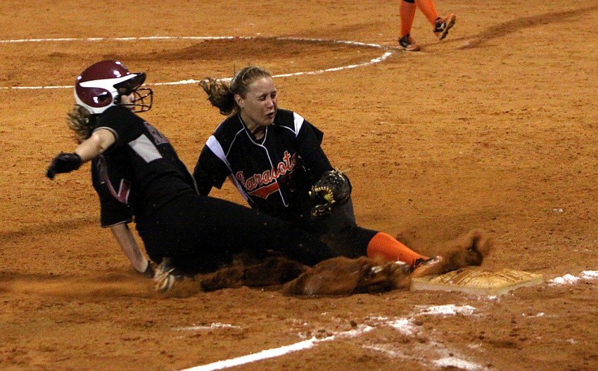 Riverviewâ€™s Courtney Kelly, No. 2, tries to slide into third base but Sarasotaâ€™s Shelby Thorpe, No. 13, beats her to the base and tags her out.