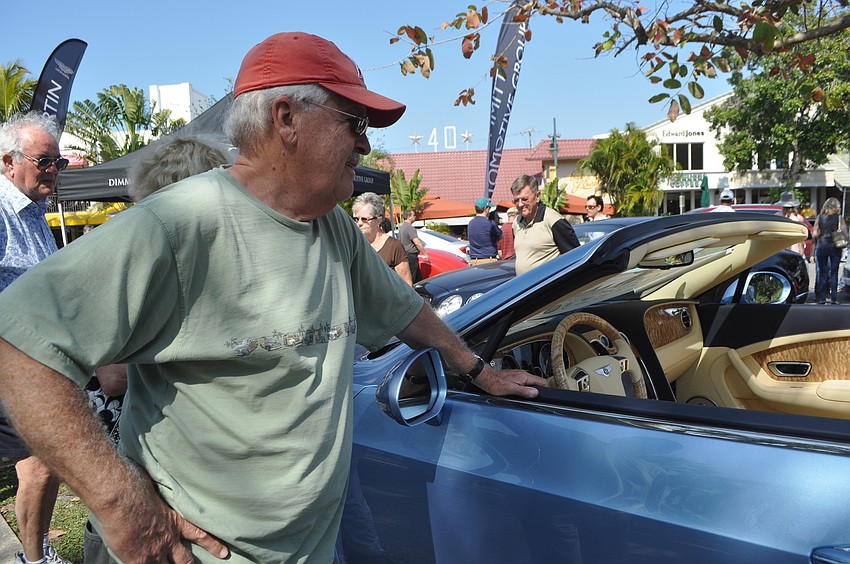 Brent Trottier admires a Bentley.