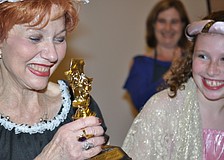 Judy Goldstein, director, receives an Oscar from Emma Katz.