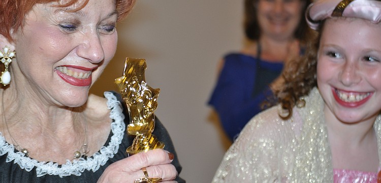 Judy Goldstein, director, receives an Oscar from Emma Katz.