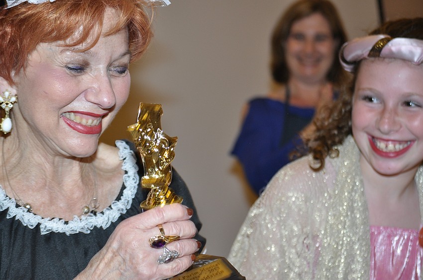 Judy Goldstein, director, receives an Oscar from Emma Katz.