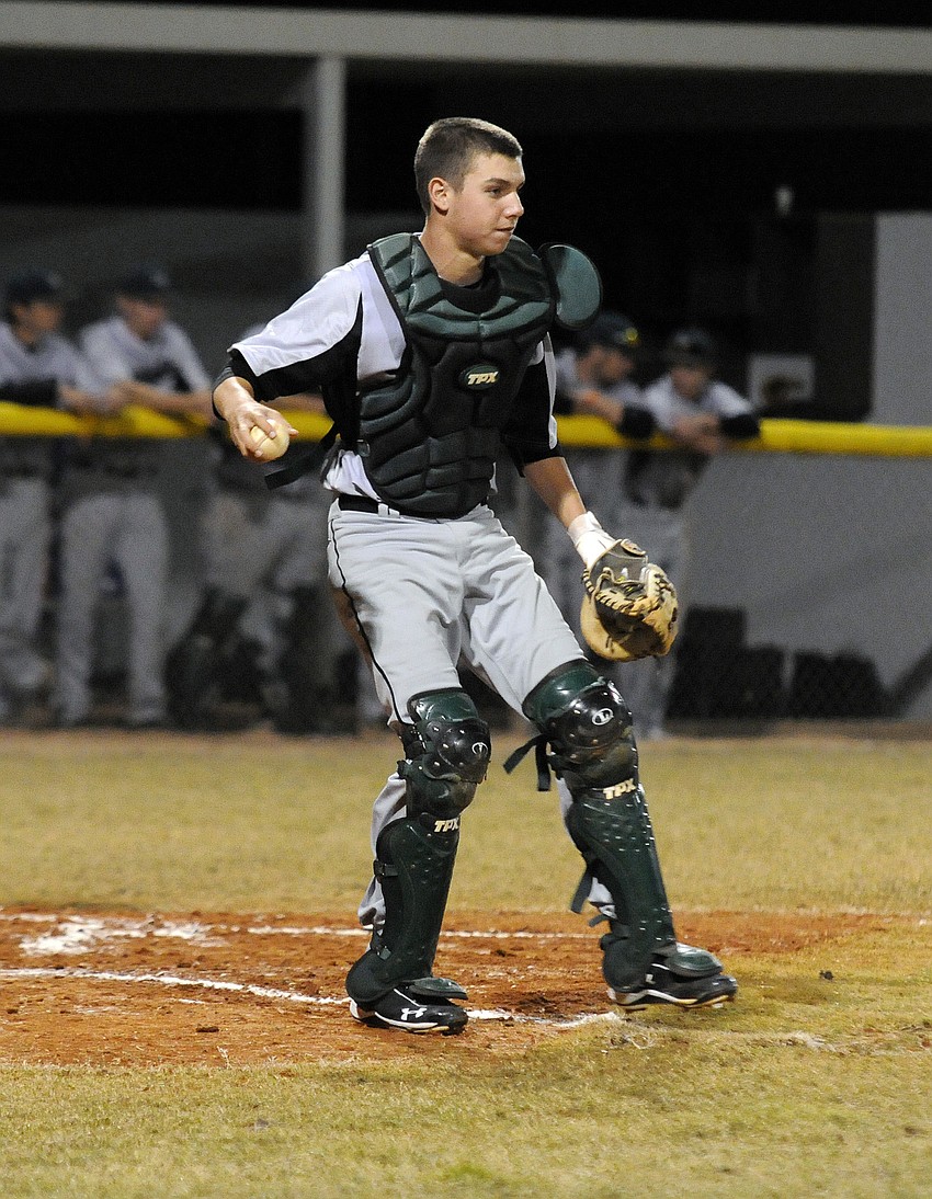 Lakewood Ranch junior catcher Andrew Giddens retrieves a foul ball during the Mustangs non-district game at Braden River.