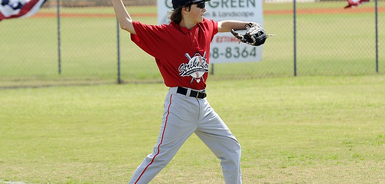 Eleven-year-old Alen Bass warms up before the start of his teamâ€™s season opener Feb. 23.