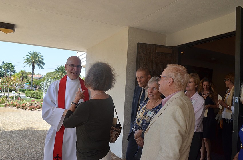 New Rector John C. N. Hall greets parishioners after service.