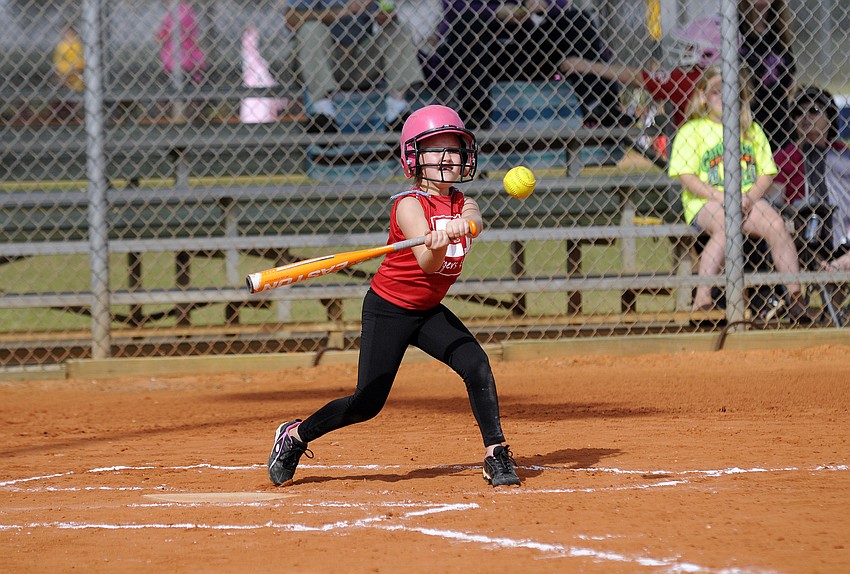 Seven-year-old Erin McIntyre makes contact during her team's season-opener versus Pemco Feb. 23.