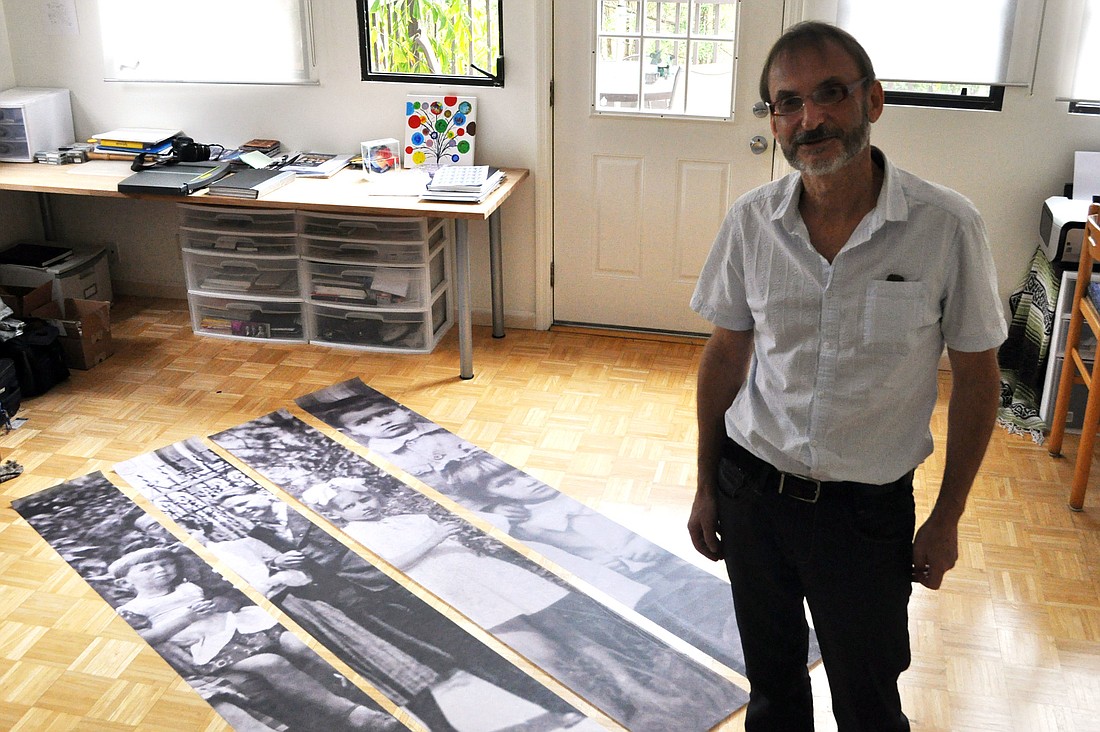 Wojtek Sawa stands with four large-scale photos that he will use in his future installation for Ã¢â‚¬Å“The Wall SpeaksÃ¢â‚¬Â project.