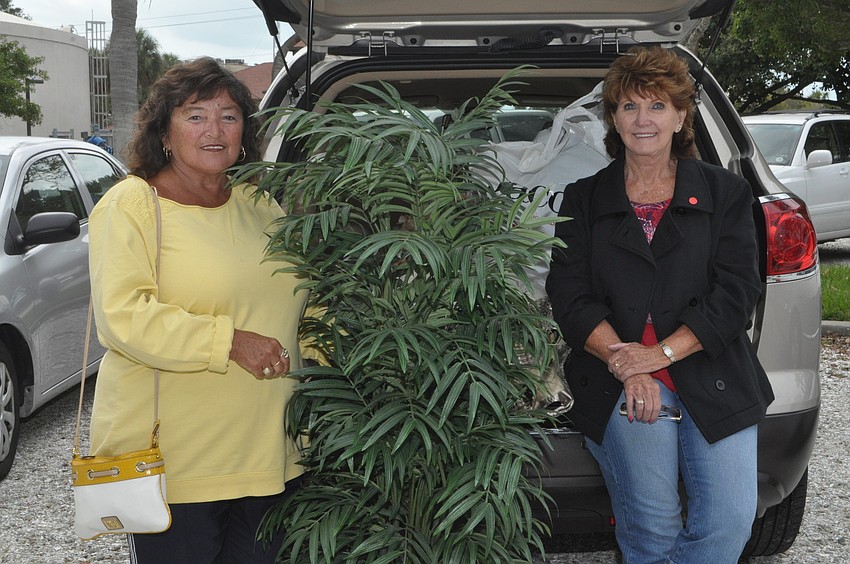 Debbie Causey and Margey Hinderliter bought a palm tree, bird house and golf clubs among a â€œcarload of itemsâ€