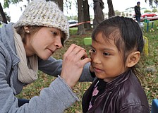 Danielle Buncik painted a yellow butterfly on the face of 4-year-old Abygail Jimenez.