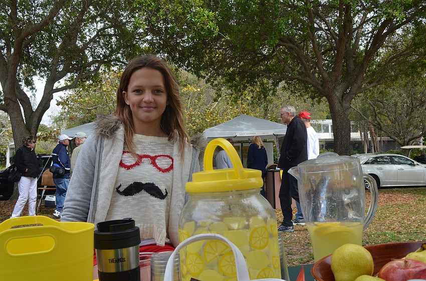 Lindsey Jennings, 11, sells refreshments at the art festival.