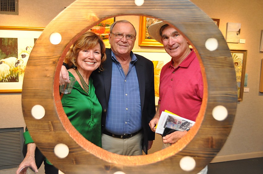 Gloria and Johnie Newcomb with Rick Crootof pose behind â€œCircle Form IXâ€ by Greg Johnson on display in  â€œSimply Originalâ€ in Gallery 4