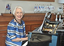 Margaret Guthman plays Broadway tunes as models stroll through the dining room.