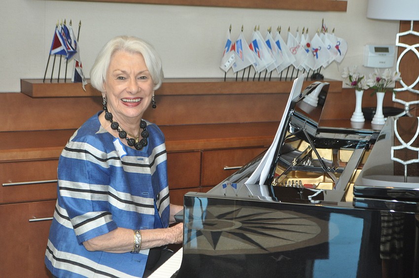 Margaret Guthman plays Broadway tunes as models stroll through the dining room.
