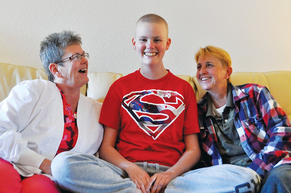 Ashley Krueger sits between her parents, Cindi Krueger and Pat Myers. Ashley Krueger is fighting T-cell lymphoma and is awaiting a bone marrow transplant. Photo by Nick Friedman