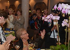 Bea Friedman blows kisses in gratitude to lunch goers for their standing ovation for her Guardian of Israel award.
