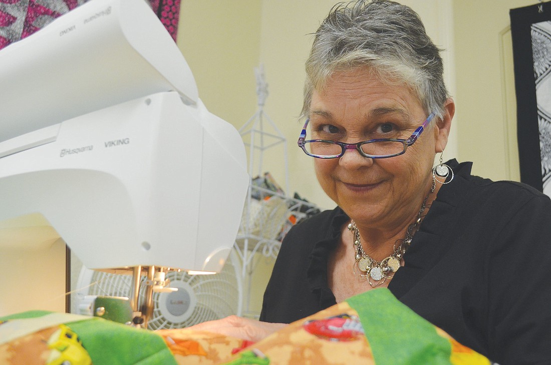 Linda Snyder sews a child's quilt.