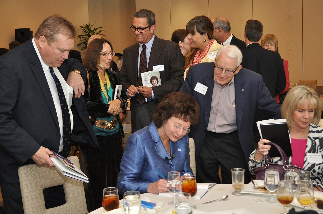 Former Tampa mayor, and author Pam Iorio signs copy of her book, Straight Forward Ã¢â‚¬â€ Ways to Live and Lead.