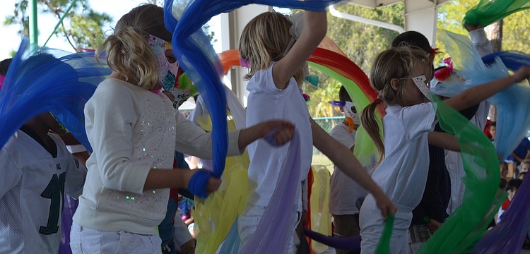First graders performed a Peruvian bird dance with masks.