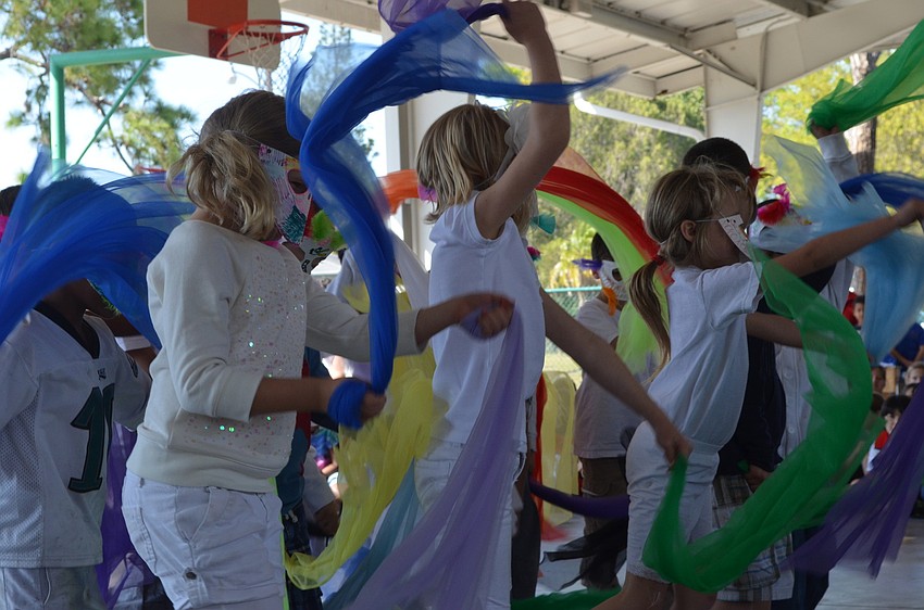 First graders performed a Peruvian bird dance with masks.